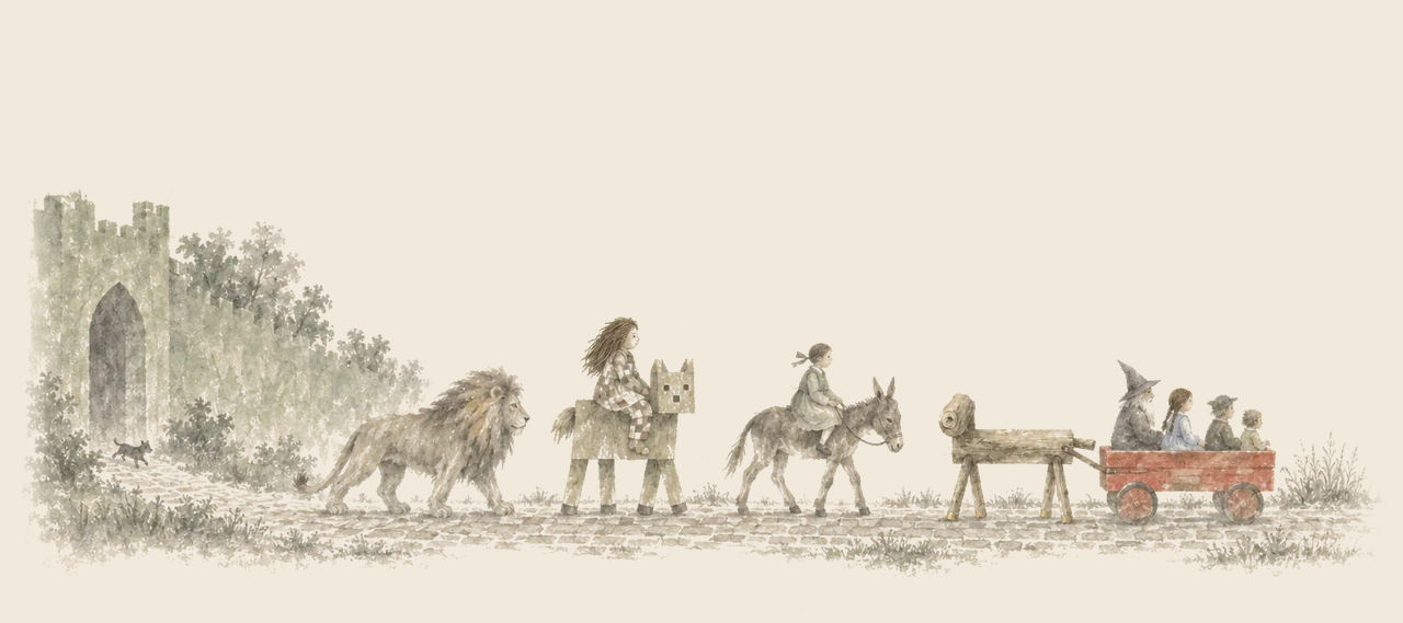 The Cowardly Lion leads a procession from a city gate: the Patchwork Girl on the Woozy, a girl on a mule, and the Sawhorse pulling a red wagon of riders.