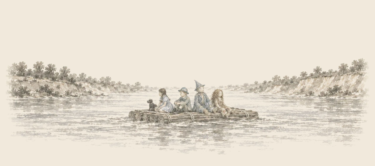 Dorothy, Ojo, the Scarecrow and the Patchwork Girl sit on a log raft carried down a broad river between high banks, with Toto beside Dorothy.